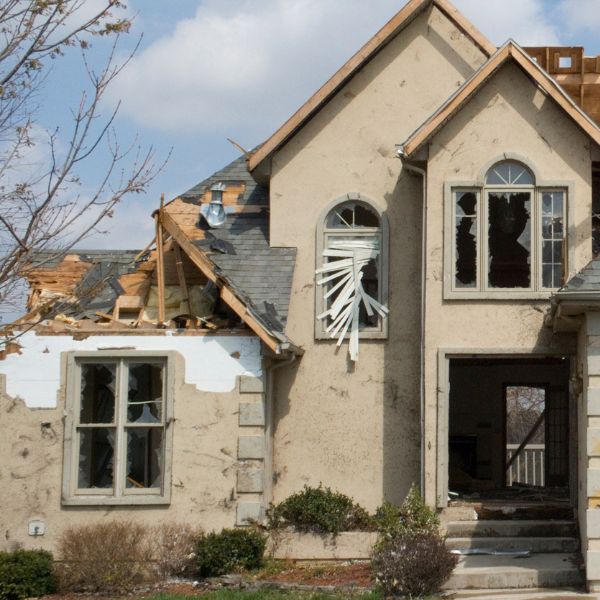 High winds damaging roof and exterior of home needing public adjuster to assist with insurance claim